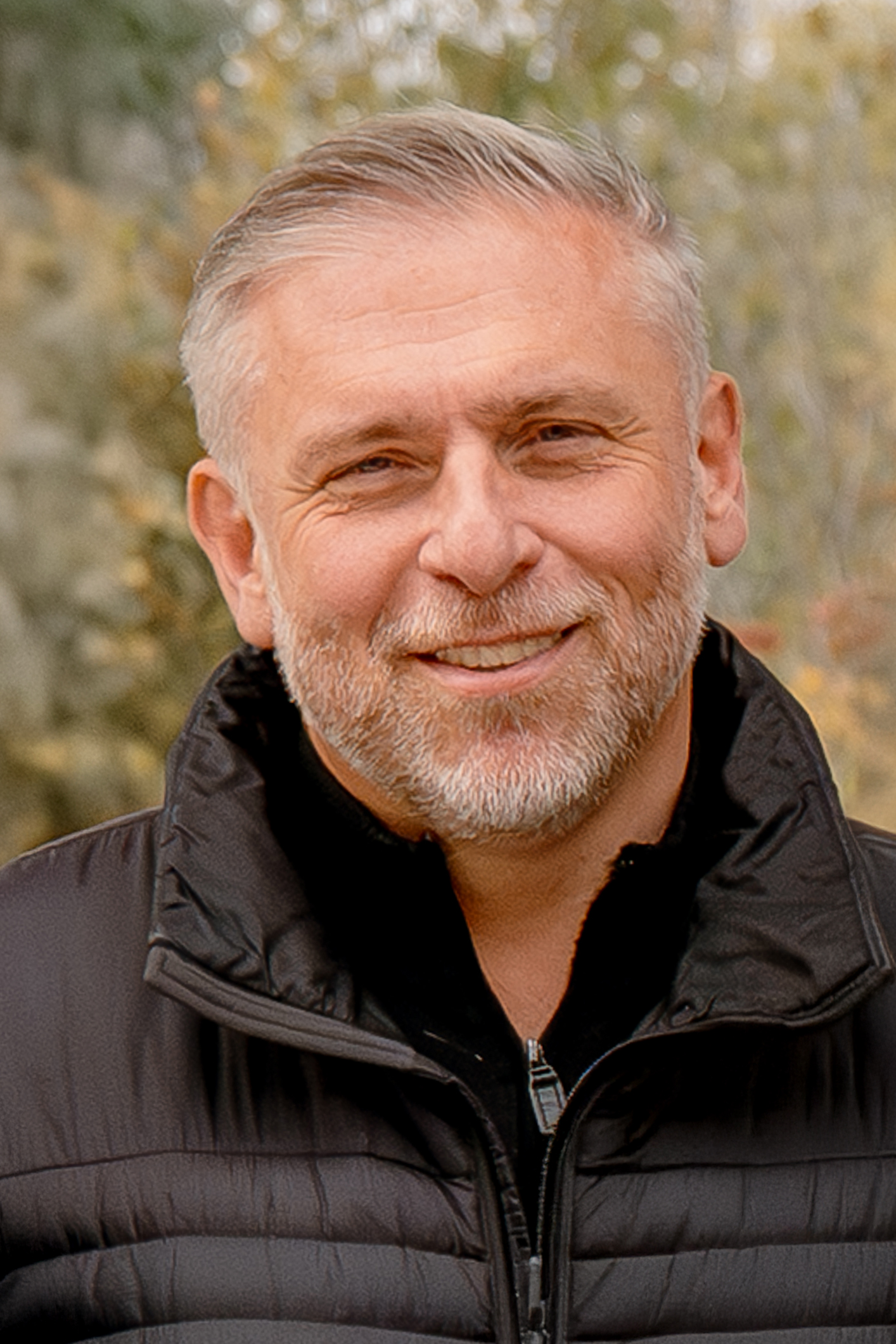 headshot of man with black jacket