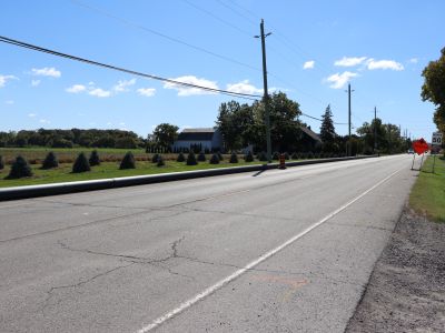 Watermain pipes laying above-ground on the other side of a road.